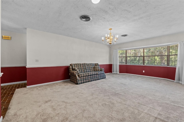 3441 Sherertz Rd, Lakeland, FL 33810 - unfurnished room with a chandelier, a textured ceiling, baseboards, and carpet flooring