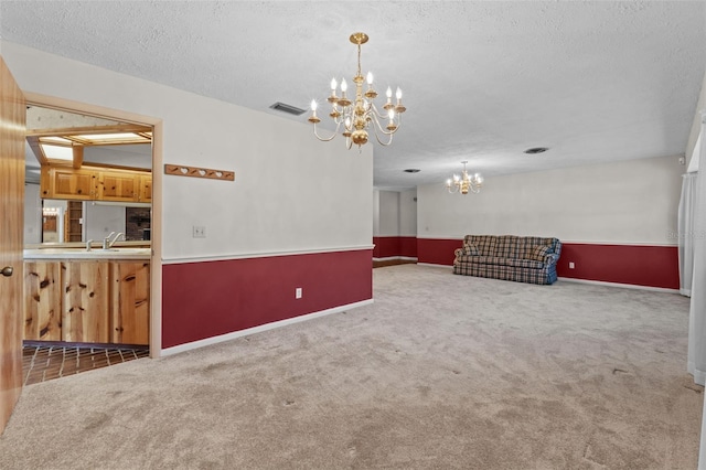 3441 Sherertz Rd, Lakeland, FL 33810 - spare room featuring a chandelier, carpet, a textured ceiling, and baseboards