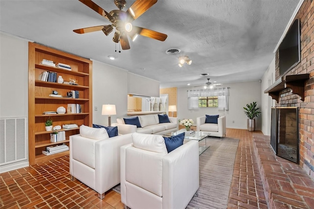 3441 Sherertz Rd, Lakeland, FL 33810 - living room with ceiling fan, brick floors, a fireplace, and built in features