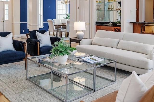living room with wet bar and a notable chandelier
