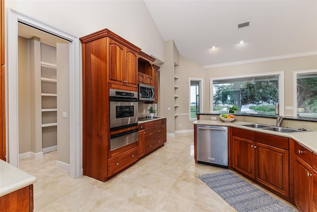 kitchen with appliances with stainless steel finishes, a sink, light countertops, visible vents, and a warming drawer