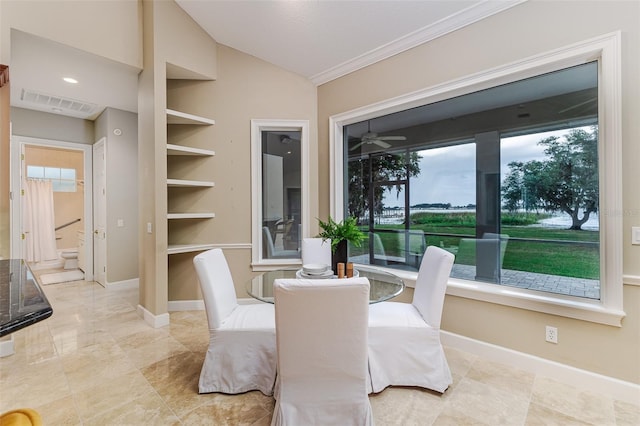 dining space featuring crown molding, baseboards, vaulted ceiling, and visible vents