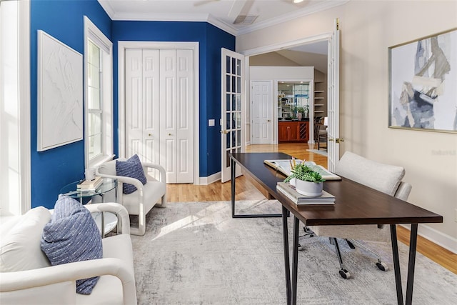 office space featuring crown molding, visible vents, wood finished floors, and baseboards