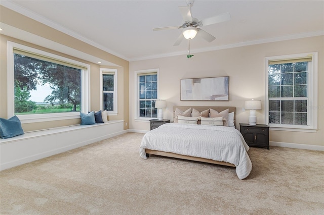 bedroom featuring baseboards, a ceiling fan, ornamental molding, and carpet floors