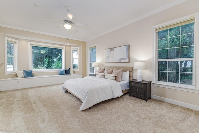 bedroom with baseboards, multiple windows, light carpet, and ornamental molding