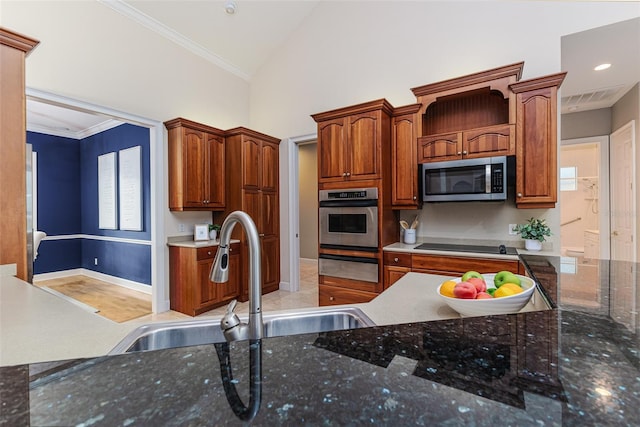kitchen featuring crown molding, lofted ceiling, a sink, a warming drawer, and stainless steel appliances