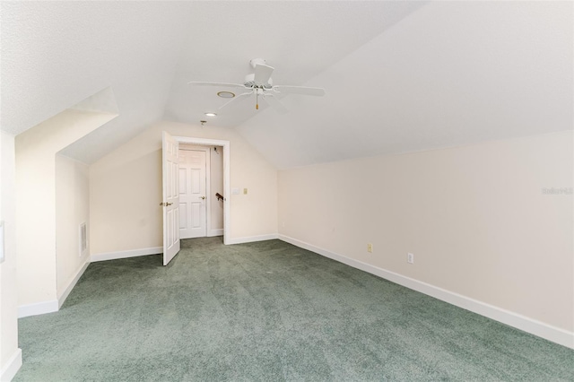 additional living space featuring carpet floors, visible vents, baseboards, a ceiling fan, and vaulted ceiling