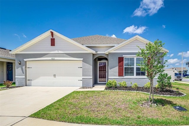 view of front facade featuring an attached garage, stucco siding, driveway, and a front yard