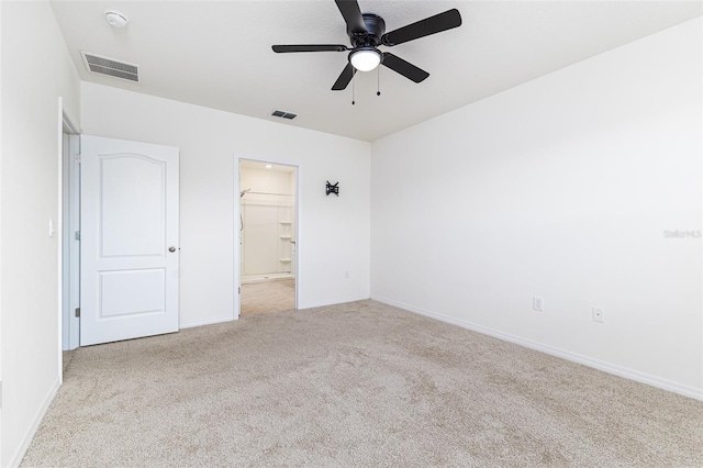 unfurnished bedroom featuring carpet floors, baseboards, and visible vents