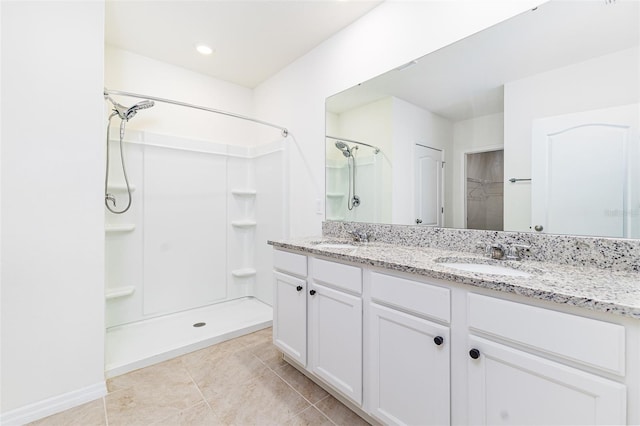 full bath featuring a spacious closet, a sink, and a walk in shower
