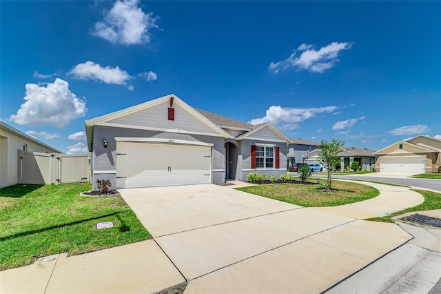 single story home with an attached garage, a gate, stucco siding, a front lawn, and concrete driveway