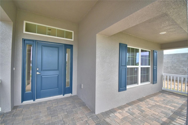 entrance to property with stucco siding