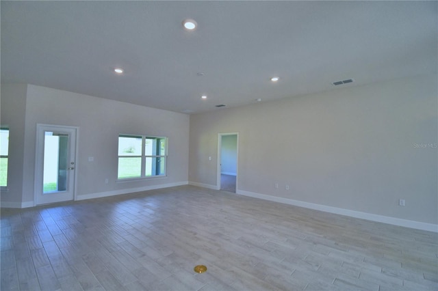empty room with recessed lighting, baseboards, visible vents, and light wood-style floors
