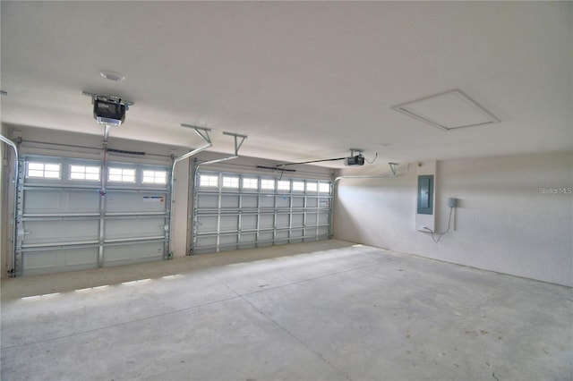 garage with a garage door opener and electric panel