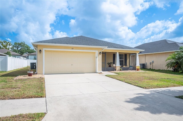single story home featuring driveway, a front yard, fence, an attached garage, and stucco siding