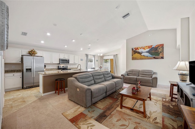 living area featuring lofted ceiling, recessed lighting, light colored carpet, and visible vents