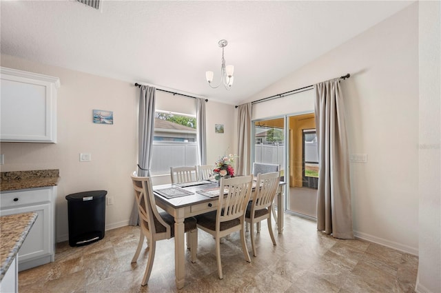 dining area with visible vents, baseboards, a notable chandelier, and lofted ceiling