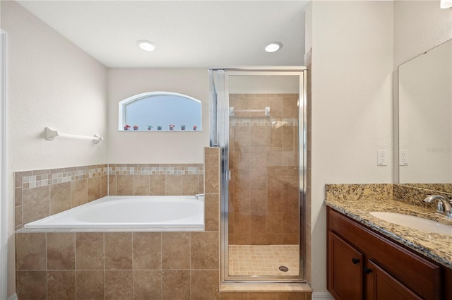 full bath with vanity, a stall shower, and a bath