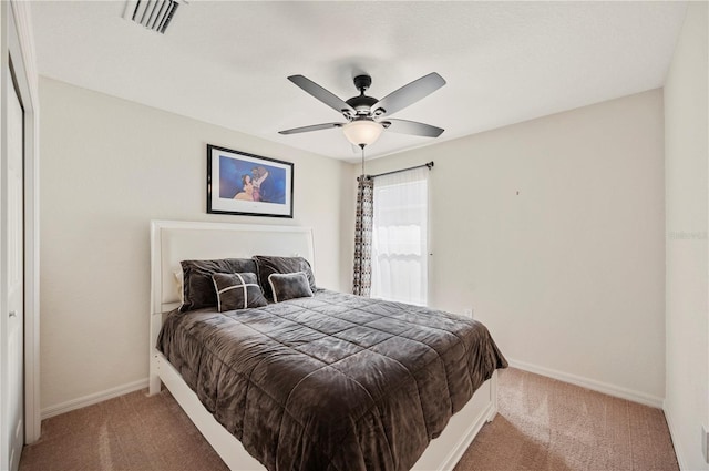 carpeted bedroom with a ceiling fan, baseboards, and visible vents