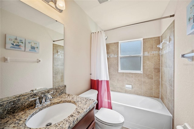 full bathroom featuring vanity, toilet, visible vents, and shower / tub combo