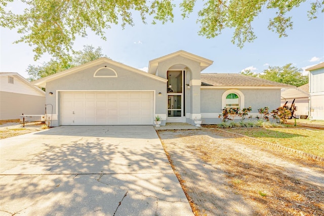 1061 Lowry Ave, Lakeland, FL 33801 - view of front facade with concrete driveway, stucco siding, and an attached garage