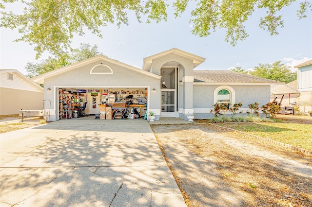 1061 Lowry Ave, Lakeland, FL 33801 - view of front of home featuring concrete driveway, a garage, and stucco siding
