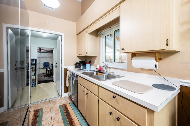 1061 Lowry Ave, Lakeland, FL 33801 - kitchen featuring light brown cabinetry, dishwasher, visible vents, a sink, and light countertops
