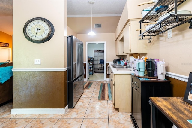 1061 Lowry Ave, Lakeland, FL 33801 - kitchen featuring freestanding refrigerator, pendant lighting, light tile patterned floors, visible vents, and a sink
