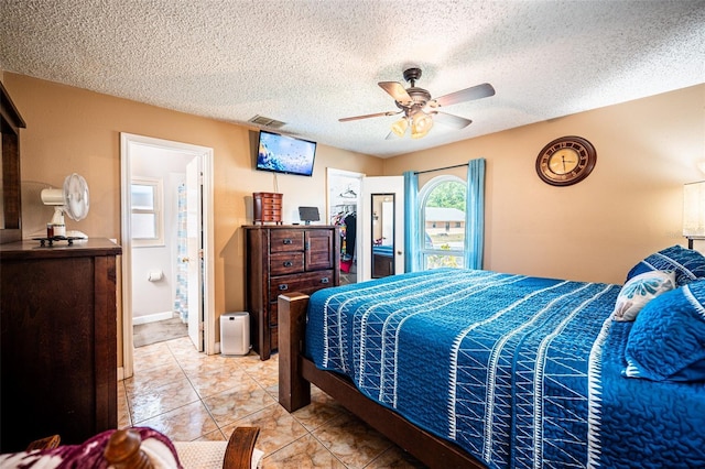1061 Lowry Ave, Lakeland, FL 33801 - bedroom with a closet, a textured ceiling, visible vents, a spacious closet, and a ceiling fan
