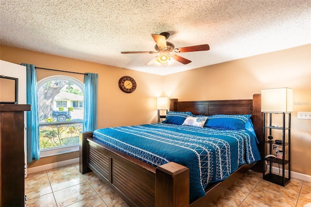 1061 Lowry Ave, Lakeland, FL 33801 - bedroom featuring a textured ceiling, baseboards, light tile patterned floors, and ceiling fan