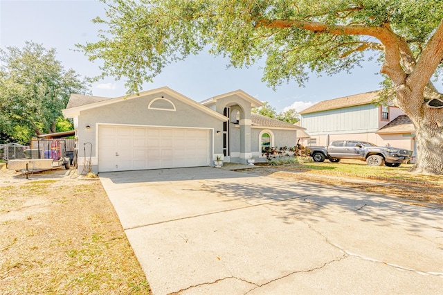 1061 Lowry Ave, Lakeland, FL 33801 - view of front facade with concrete driveway, stucco siding, and an attached garage