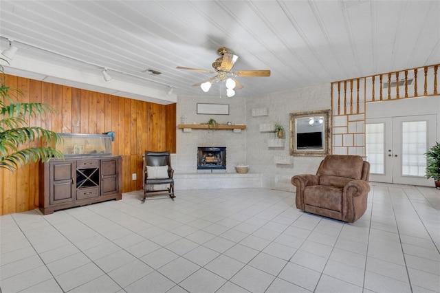 living room with a ceiling fan, rail lighting, light tile patterned floors, and visible vents