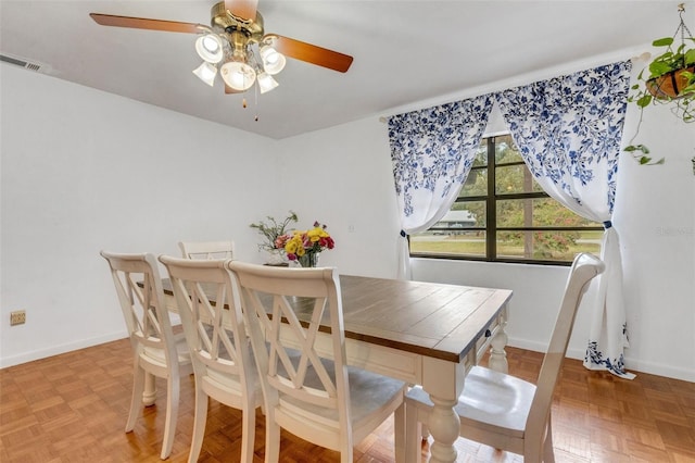dining area with a ceiling fan, baseboards, and visible vents