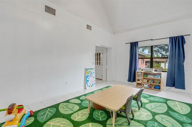 playroom with high vaulted ceiling, light tile patterned floors, and visible vents