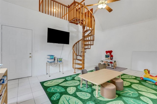 interior space featuring high vaulted ceiling, a ceiling fan, and tile patterned floors