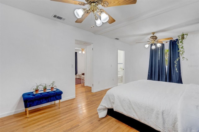 bedroom featuring baseboards, light wood-style floors, visible vents, and a ceiling fan