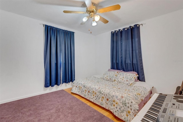 bedroom with a ceiling fan and wood finished floors