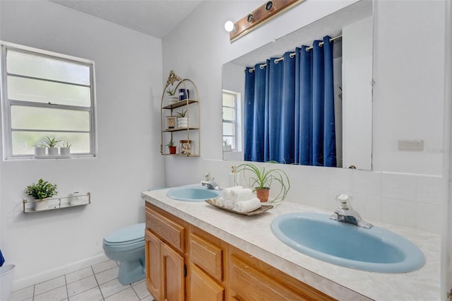 full bathroom with toilet, tile patterned flooring, tasteful backsplash, and a sink