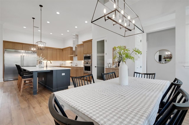 2551 Delphi Woods Cir, Lakeland, FL 33812 - dining room with a chandelier, light wood finished floors, recessed lighting, and a towering ceiling