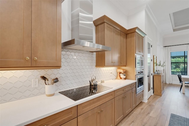 2551 Delphi Woods Cir, Lakeland, FL 33812 - kitchen with wall chimney range hood, appliances with stainless steel finishes, crown molding, light wood-style flooring, and light countertops