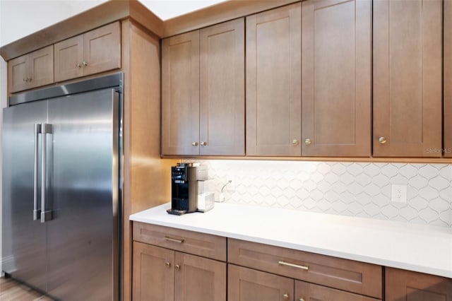 2551 Delphi Woods Cir, Lakeland, FL 33812 - kitchen featuring built in refrigerator, light countertops, and decorative backsplash