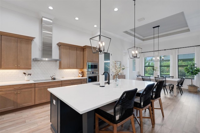 2551 Delphi Woods Cir, Lakeland, FL 33812 - kitchen featuring stainless steel appliances, wall chimney range hood, a chandelier, a sink, and ornamental molding