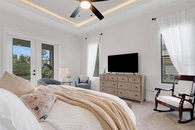 2551 Delphi Woods Cir, Lakeland, FL 33812 - bedroom featuring light colored carpet, access to outside, a raised ceiling, baseboards, and a ceiling fan