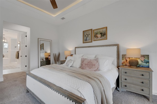 2551 Delphi Woods Cir, Lakeland, FL 33812 - carpeted bedroom with ensuite bath, a raised ceiling, ceiling fan, and a chandelier