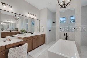 2551 Delphi Woods Cir, Lakeland, FL 33812 - full bath featuring a chandelier, a bath, and walk in shower