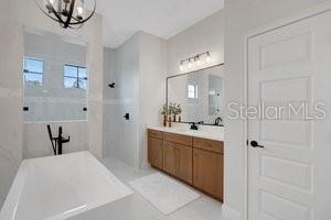 2551 Delphi Woods Cir, Lakeland, FL 33812 - bathroom with a tub, plenty of natural light, a chandelier, and vanity