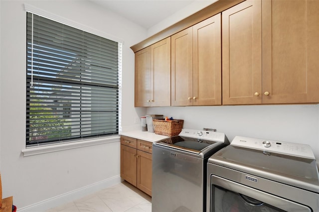 2551 Delphi Woods Cir, Lakeland, FL 33812 - laundry room featuring light marble finish floors, cabinet space, independent washer and dryer, and baseboards