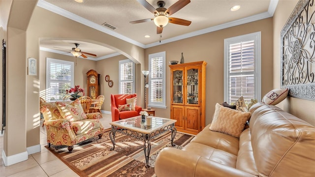 living area featuring ceiling fan, arched walkways, baseboards, crown molding, and recessed lighting