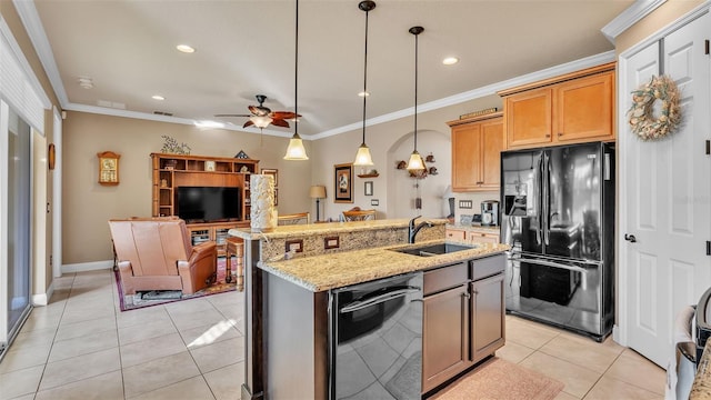 kitchen featuring black appliances, a sink, open floor plan, light stone counters, and light tile patterned floors