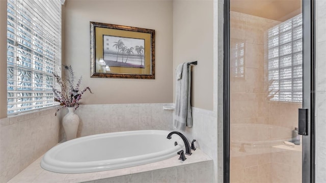 bathroom featuring a garden tub and a stall shower